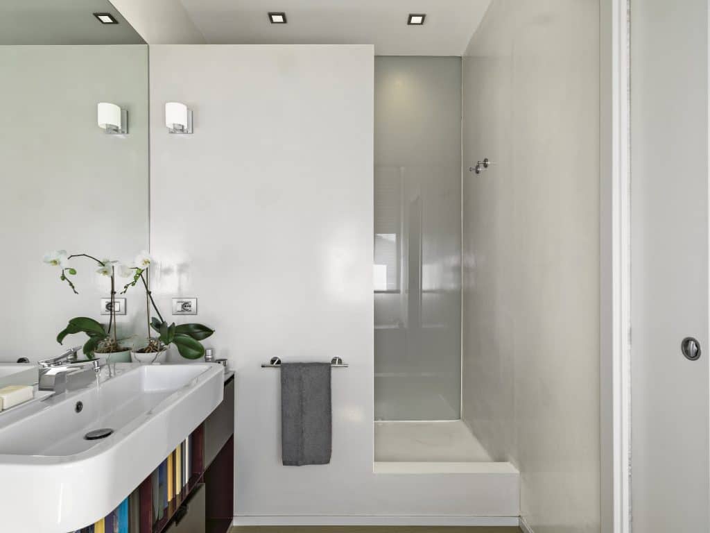 interiors shots of a modern bathroom in the foreground the contertop washbasin on the bottom the masonry shower cubicle