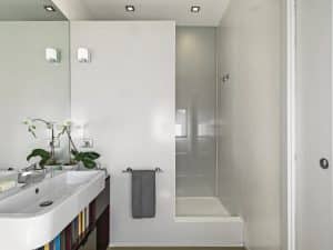 interiors shots of a modern bathroom in the foreground the contertop washbasin on the bottom the masonry shower cubicle