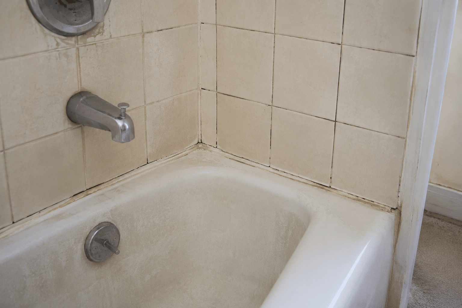 Aged bathtub and tiled corner