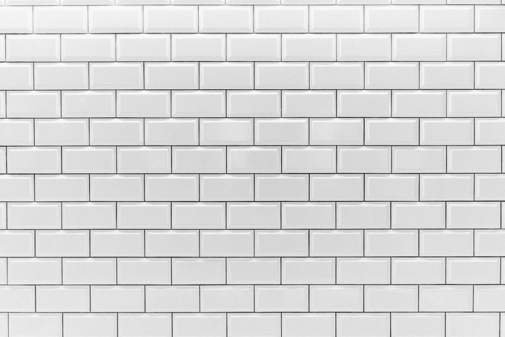 White subway tile wall with grout lines between each tile